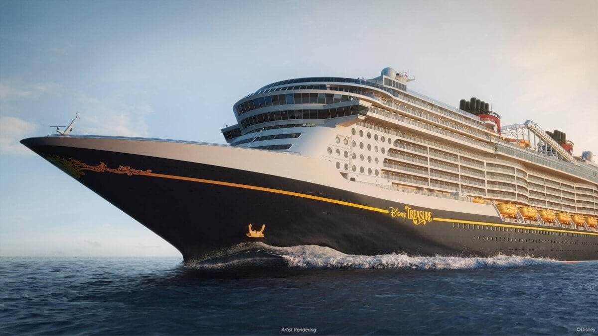 A large cruise ship with black and yellow colors, reminiscent of the Disney Treasure, sails on the ocean under clear skies. The ship features multiple decks, a sleek design, and Good Eats at its featured dining venues.