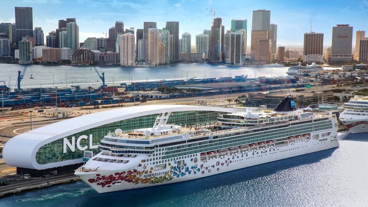 The Norwegian Gem cruise ship docked in the port of Jacksonville, ready to start service amidst the picturesque backdrop of the city.