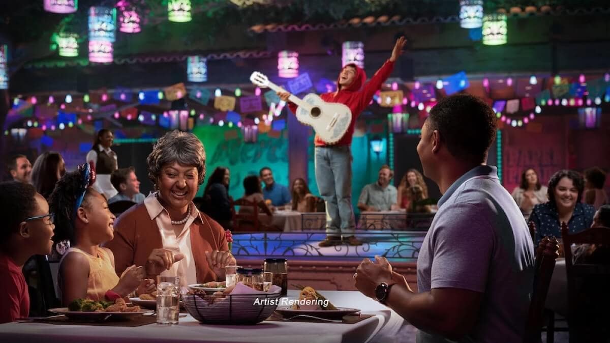 A family enjoys a meal at one of Disney Treasure's featured dining venues, where colorful surroundings blend perfectly with the joy of combining good eats with entertainment, highlighted by a guitar-playing performer on stage.